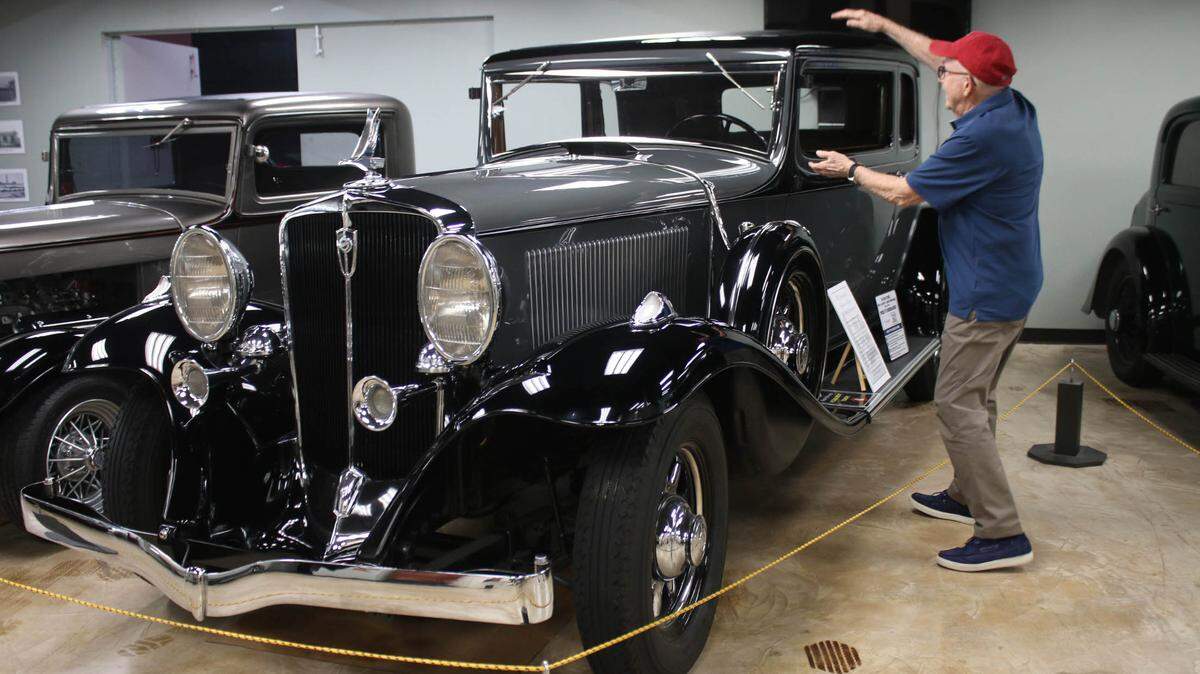 Volunteer docent Jim Clock loves to point out the special features of each car on display for visitors at the Kansas City Automotive Museum in Olathe.