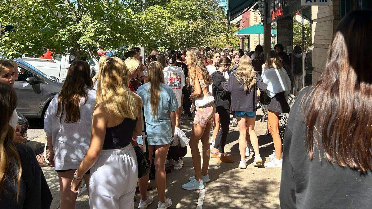 Students and Swifties fill the sidewalks on Massachusetts Street in Lawrence, Kansas, on Monday afternoon after rumors spread that the pop star was at a brewery near the University of Kansas.