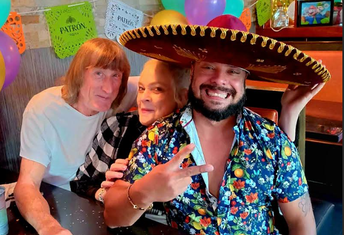 Erin Spiridigliozzi (center) poses with Victor Roman (right) at Los Guapos Latin Food in Lawrence.