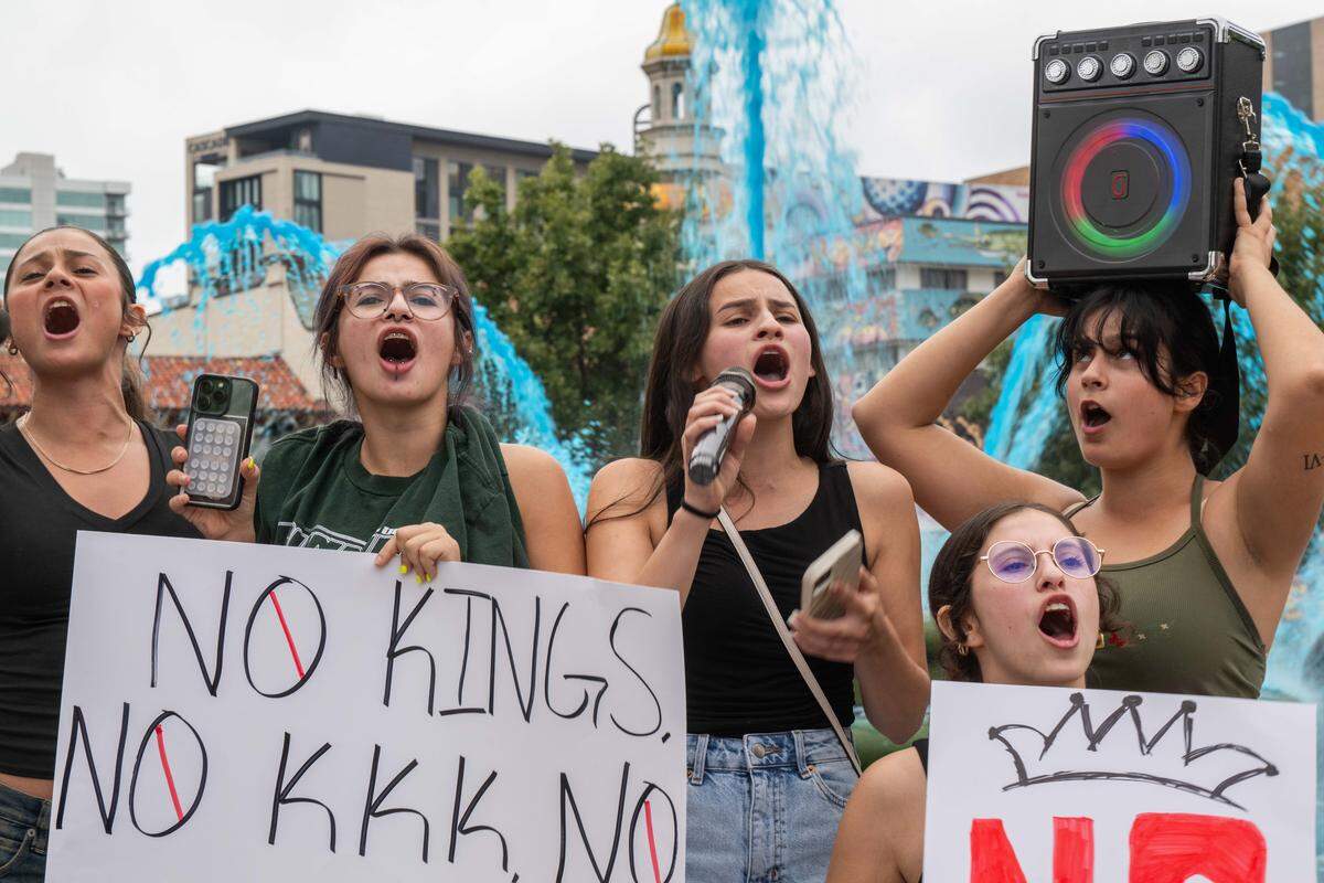 Demonstrators rally on Saturday, October 18, 2025, at Mill Creek Park in Kansas City as part of nationwide “No Kings” protests against the Trump administration. Protesters dressed up in costumes and brought signs showing their displeasure.
