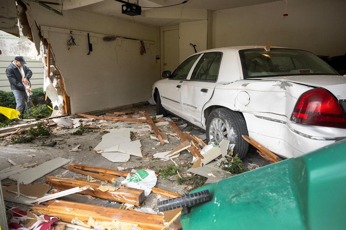 David Carpenter looks over the damage caused after a driver mistakenly hit the gas instead of the brakes and plowed into his garage, severely damaging the townhouse in the 11700 block of Grant Drive in the Hunter’s Pointe neighborhood of Overland Park on Tuesday, April 1, 2025.