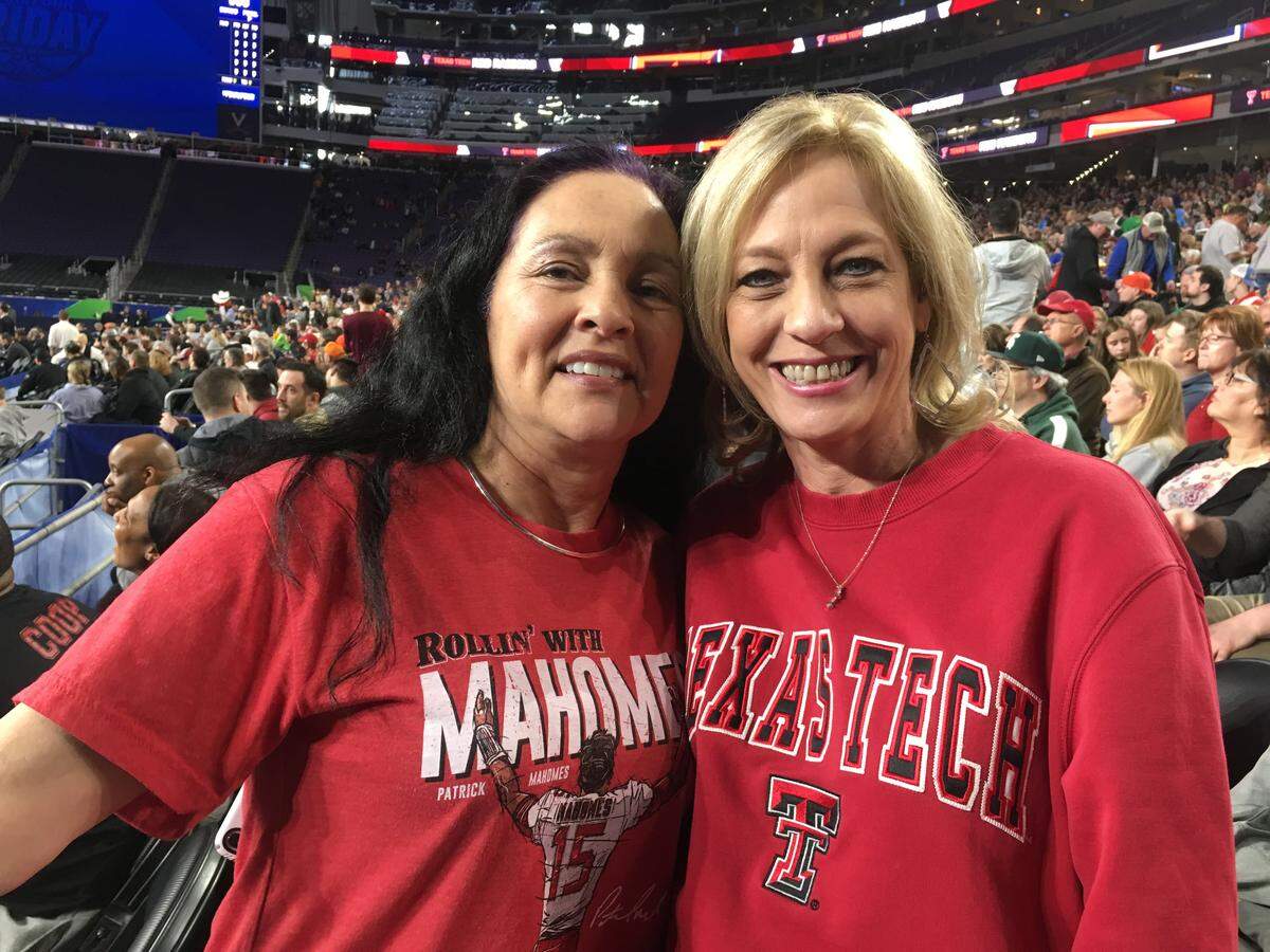 Texas Tech fans Lyn Moreno (left) and Shelia Cunningham of Lubbock, Texas, watch the Red Raiders’ open practice at the Final Four ... while keeping an eye out for Tech alum and Chiefs star Patrick Mahomes