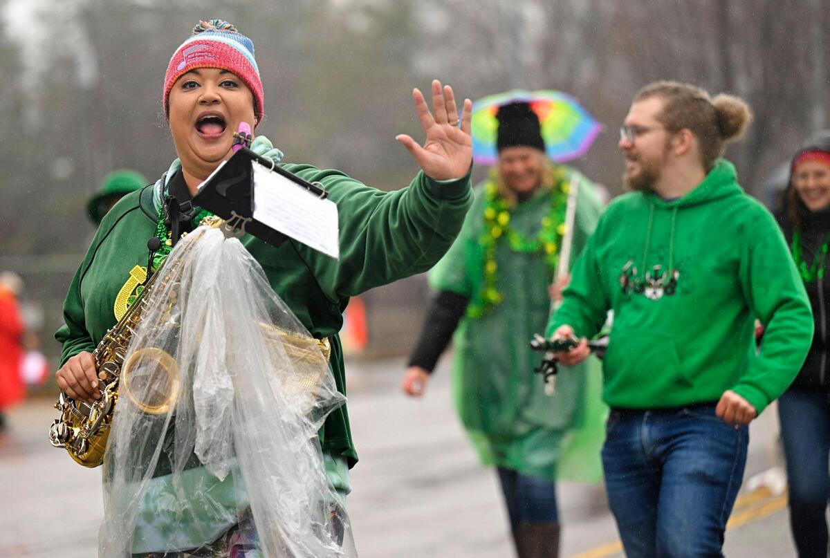 Members of the Mid America Freedom Band marched in the rain during the 2023 Brookside St. Patrick’s Day Warm-Up Parade on Saturday March 11, 2023 in Kansas City.