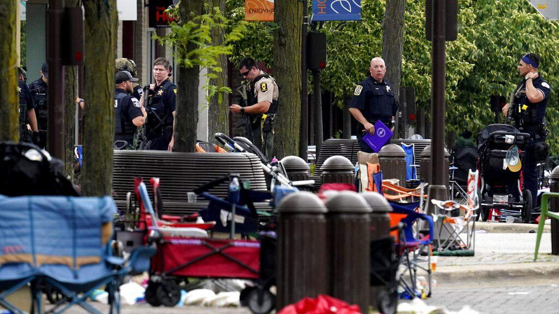 Law enforcement search after a mass shooting at the Highland Park Fourth of July parade in downtown Highland Park, Ill., on Monday, July 4, 2022. (AP Photo/Nam Y. Huh)