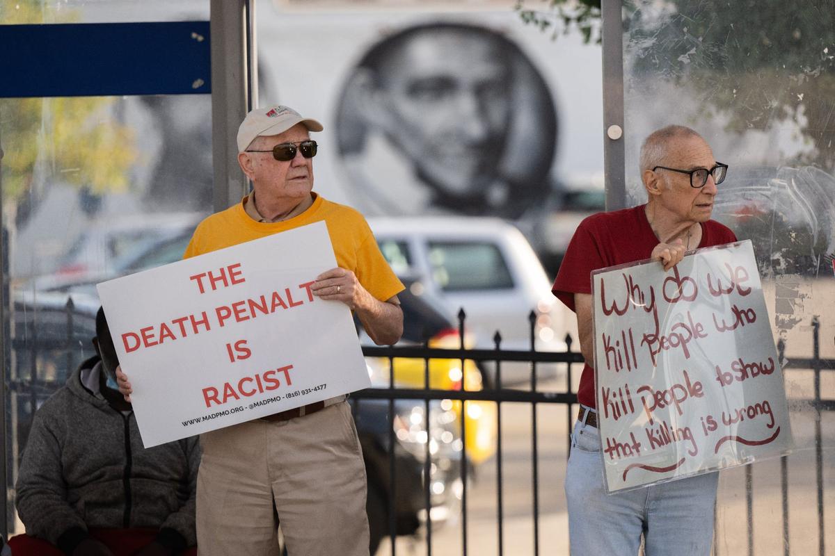 Protesters hold signs at a protest at the corner of 39th and Troost in Kansas City on Tuesday, Sept. 24, 2024. Williams executed shortly after 6 p.m. after several appeals were rejected and Gov. Mike Parson denied clemency.