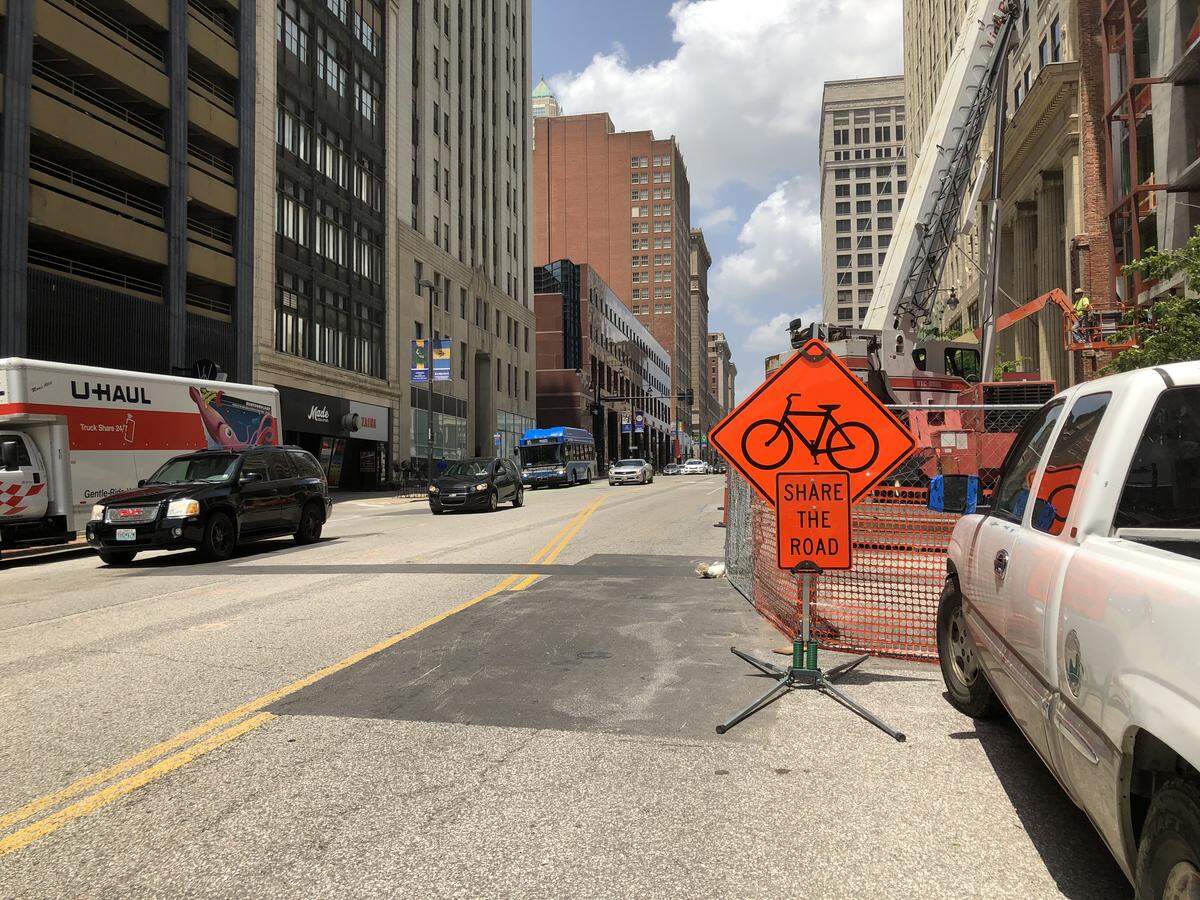 Downtown Kansas City cyclists have to share a small slice of road with cars when the new Grand Boulevard bike lanes are blocked by construction.