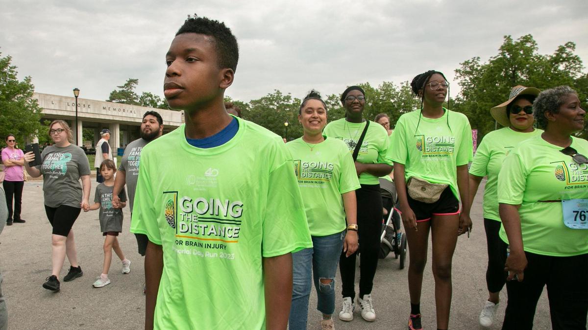Ralph Yarl, (front) the Staley High School teen shot in the head in April after ringing the wrong doorbell, and family members participated in the 1.5K walk at the Going the Distance for Brain Injury Annual run, Memorial Day, May 29, 2023 at Loose Park.