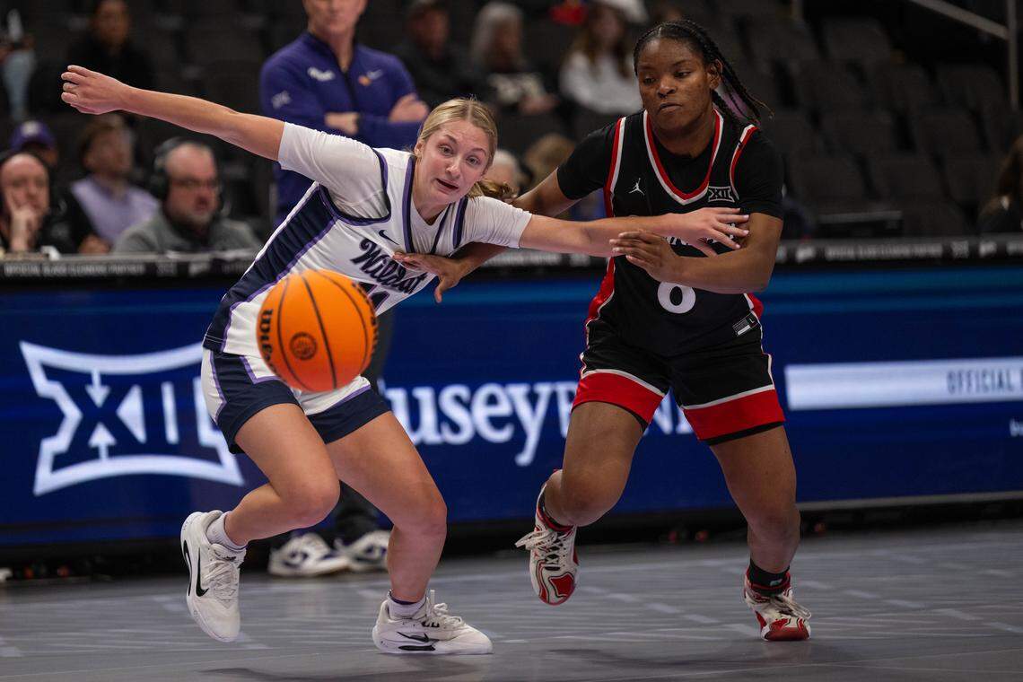 Kansas State guard Taryn Sides (11) battles for a loose ball against Cincinnati Bearcats guard Joya Crawford (8) in the first half of the Wildcats’ first-round game vs. the Cincinnati Bearcats in the Big 12 Women's Basketball Tournament.