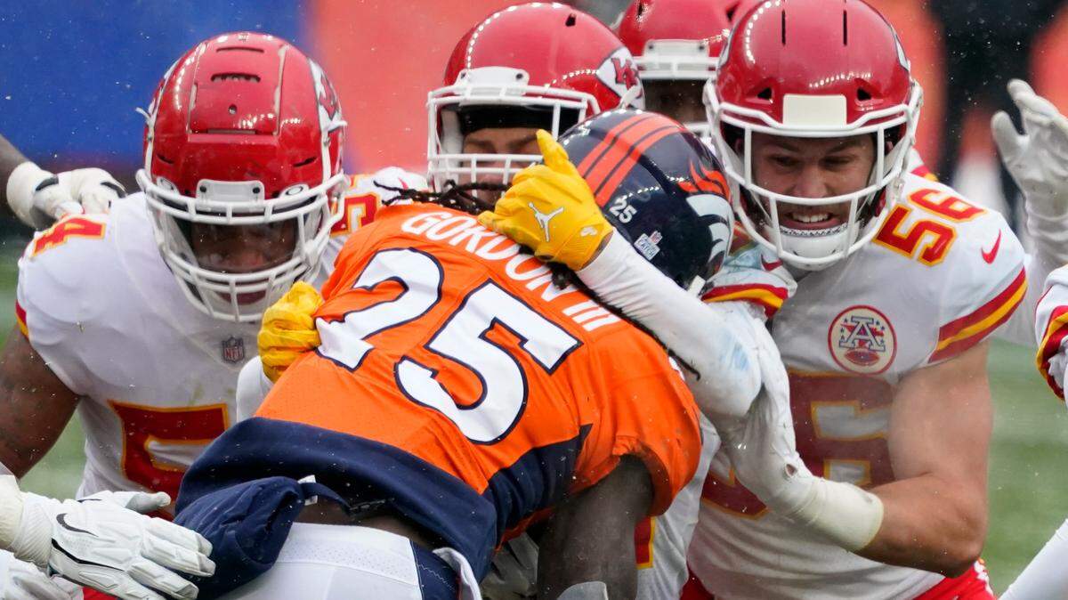 Denver Broncos running back Melvin Gordon (25) is brought down by Kansas City Chiefs linebacker Ben Niemann (56) and others during the first half of an NFL football game Sunday, Oct. 25, 2020, in Denver. (AP Photo/Jack Dempsey)