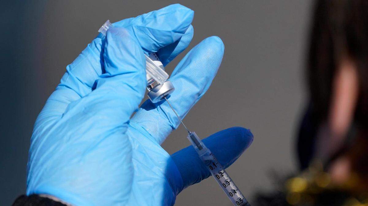 A nurse fills a syringe with COVID-19 vaccine at a mass vaccination site in Kansas City, Mo., Friday, March 19, 2021.