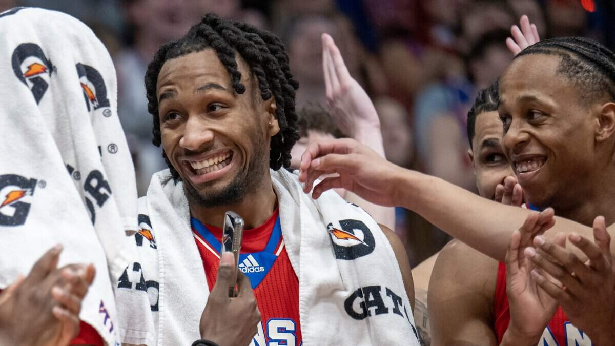 Kansas Jayhawks guard Darryn Peterson (22) laughs as guard Elmarko Jackson (13), right, and others look on when Peterson was acknowledged on Senior Day, despite not being a senior, at Allen Fieldhouse on Saturday, March 7, 2026, in Lawrence, Kansas.