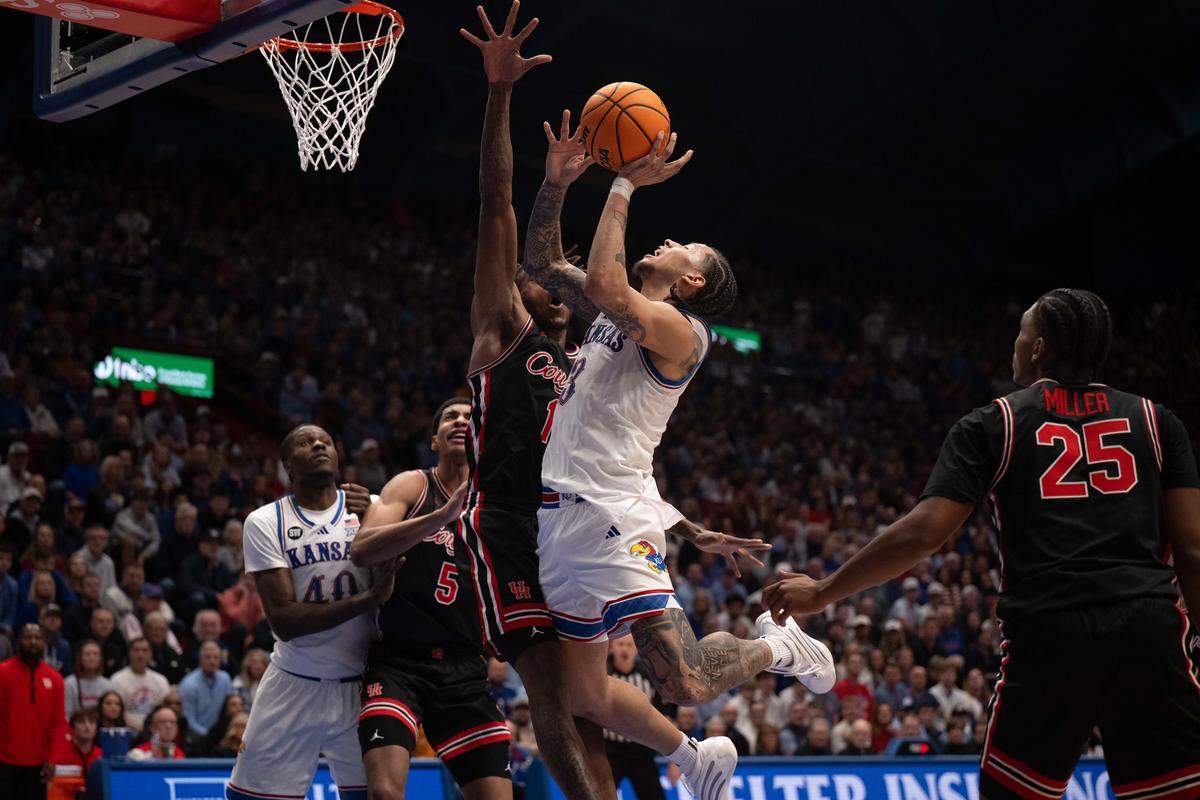Kansas Jayhawks guard Tre White (3) drives into the lane and gets fouled in the first half of the Jayhawks game vs. the Houston Cougars on Monday, February 23, 2026, at Allen Fieldhouse.