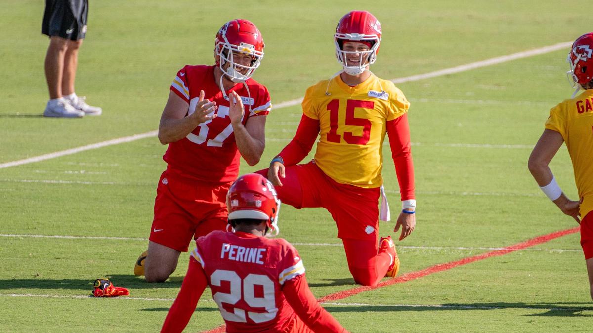 Kansas City Chiefs tight end Travis Kelce (87) and quarterback Patrick Mahomes (15) share a laugh while warming up during practice at Chiefs training camp on Friday, Aug. 11, 2023, in St. Joseph, Mo.
