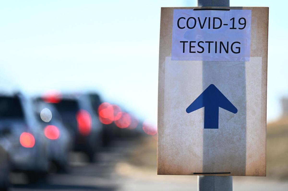 An arrow guides drivers to a COVID-19 testing site in the parking lot at Kauffman Stadium on Monday, January 10, 2022.