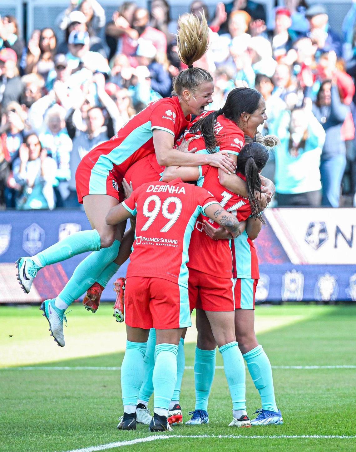 Kansas City Current teammates pile on midfielder Vanessa DiBernardo (16) after she scored the first goal of the game against the Portland Thorns during the home opener for the Current Saturday, March 16, 2024 at CPKC Stadium.