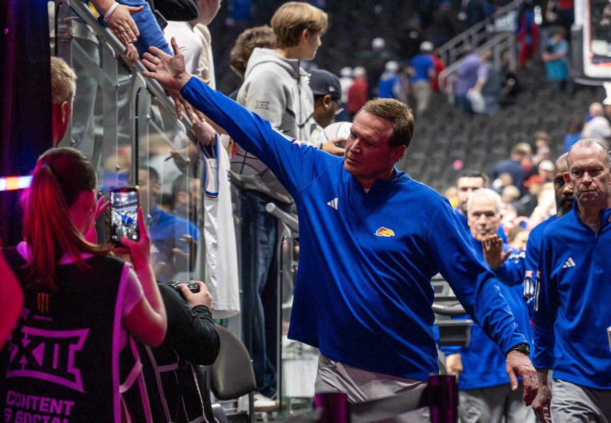 Kansas head coach Bill Self gives high-fives to fans after Kansas defeated TCU 78-73 in a Big 12 Men's Basketball Tournament game at T-Mobile Center on Thursday, March 12, 2026, in Kansas City.
