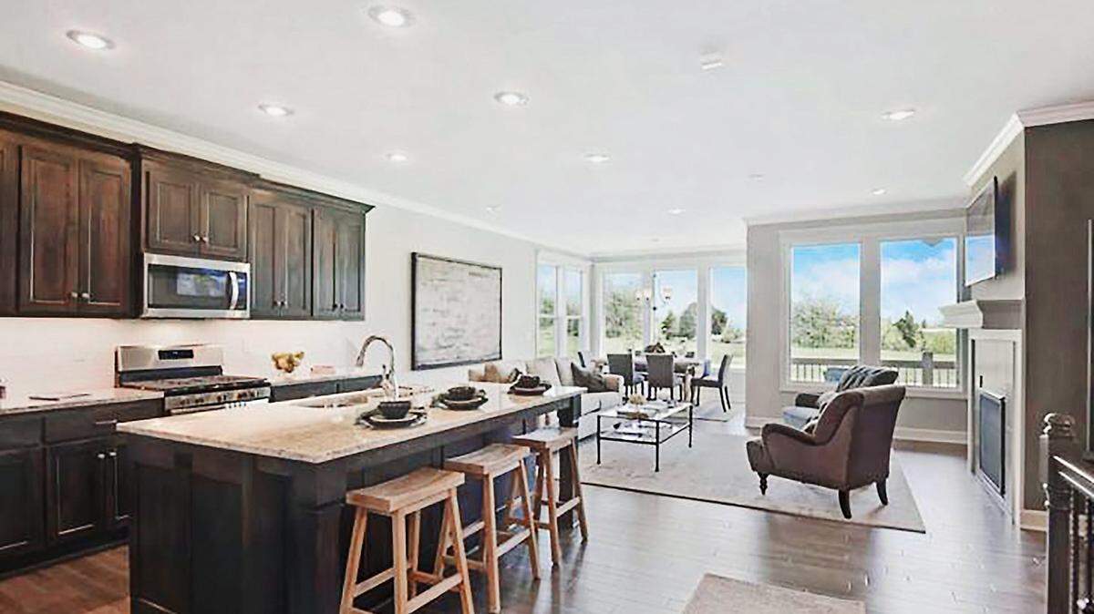 The chef-inspired kitchen includes a gas stove-top and walk-in pantry and opens to the spacious living area, providing the perfect flow for effortless entertaining. Floor to ceiling windows provide beautiful golf course views.