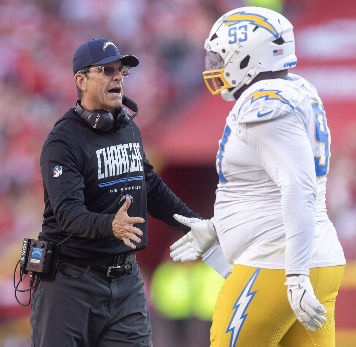 Los Angeles Chargers head coach Jim Harbaugh congratulates defensive tackle Teair Tart (93) after a fourth down stop agains the Chiefs during the second half on Sunday at Arrowhead Stadium.