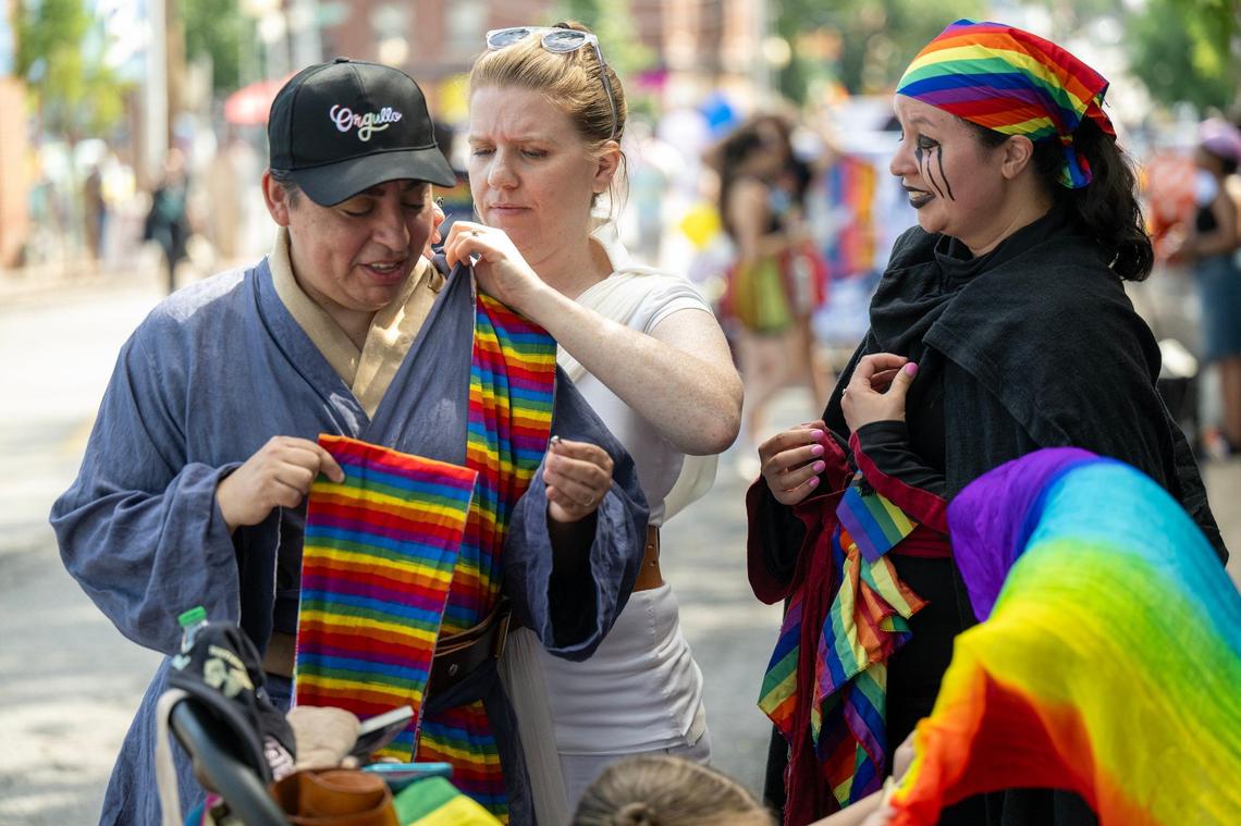 Brenda Linares, left, had her costume adjusted by her wife, Emily Vardell , of Olathe, as Sarah Thesman of Overland Park looked on at the KC Pride Parade on Saturday in Kansas City. The group was with the KC Star Wars Alliance.