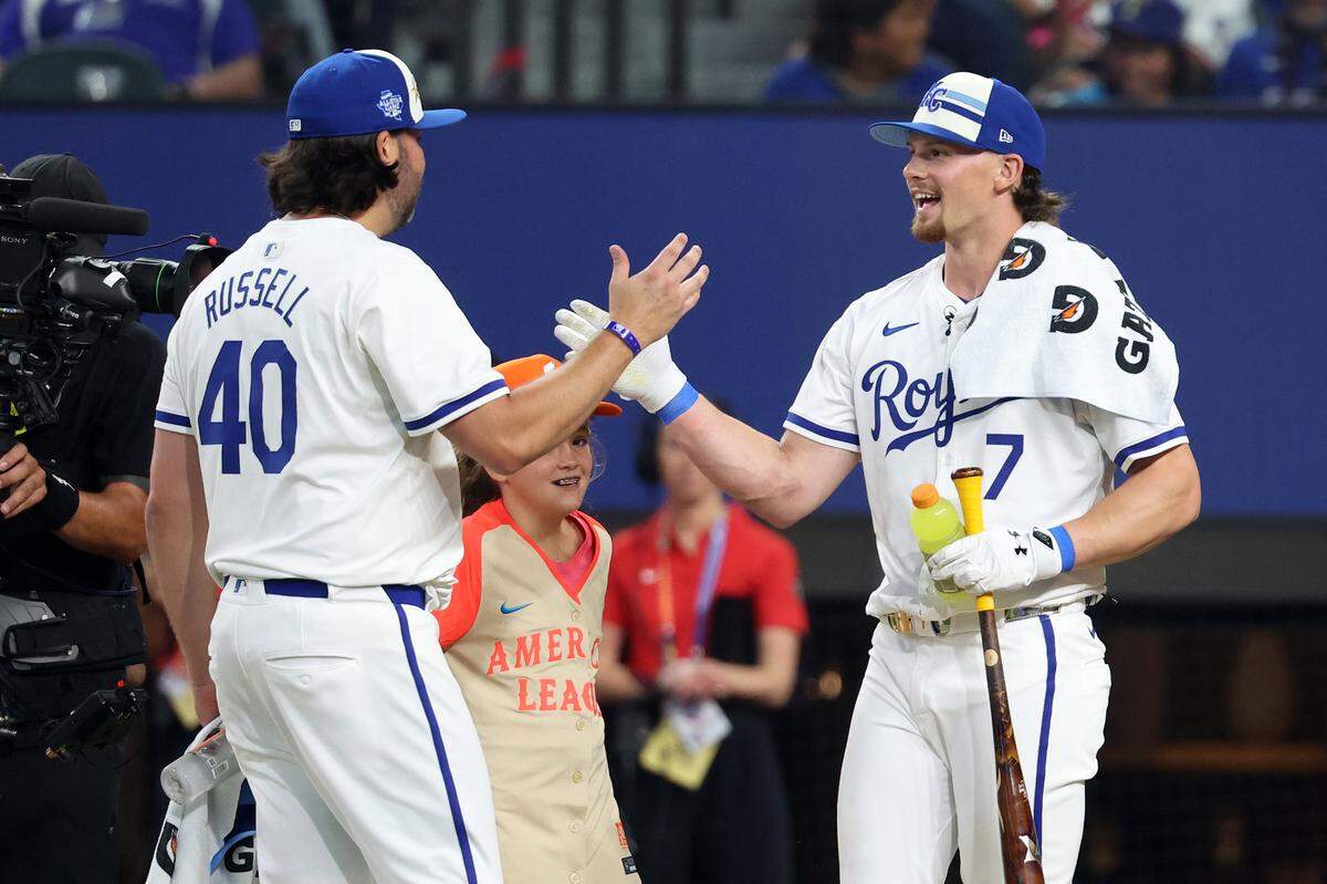 Kansas City Royals shortstop Bobby Witt Jr., right, shakes hands with his pitcher, brother-in-law James Russell, during Monday night’s Home Run Derby at Globe Life Field in Arlington, Texas.