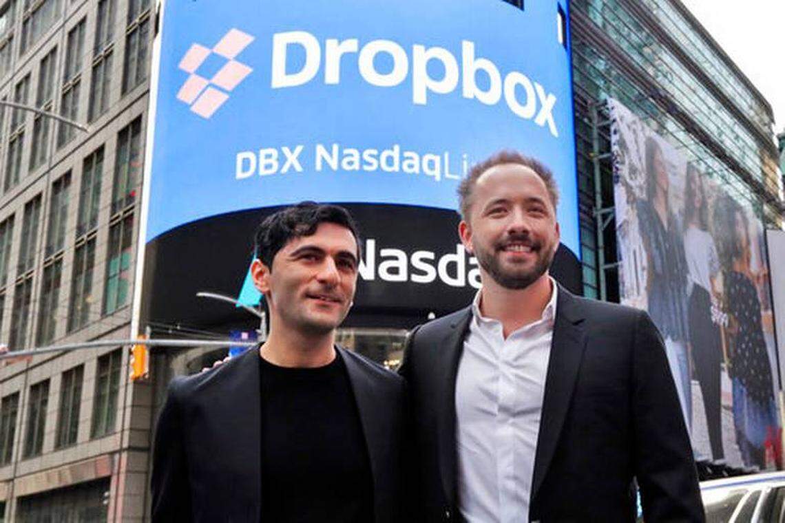 Dropbox co-founders Arash Ferdowsi of Overland Park (left) and Drew Houston were all smiles outside the Nasdaq MarketSite in New York's Times Square during their company's debut on the stock market Friday, March 23.