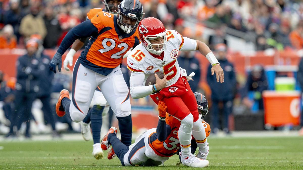Denver Broncos safety Justin Simmons (31) tackles Kansas City Chiefs quarterback Patrick Mahomes (15) during an NFL football game at Empower Field at Mile High on Sunday, Oct. 29, 2023, in Denver.
