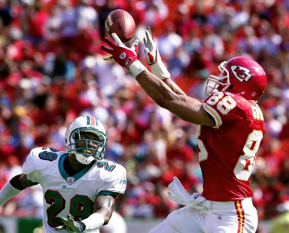 Kansas City Chiefs tight end Tony Gonzales (88) catches a third quarter touchdown pass in front of Miami Dolphins Brock Marion (29) on Sept. 29, 2002 game at Arrowhead Stadium. Gonzalez had three touchdowns on the day against the Dolphins.