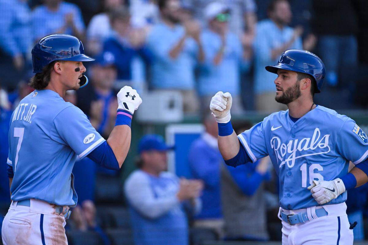 Bobby Witt Jr., left, and Royals teammate Andrew Benintendi celebrate a run during Kansas City’s season-opening series against the Cleveland Guardians at Kauffman Stadium.