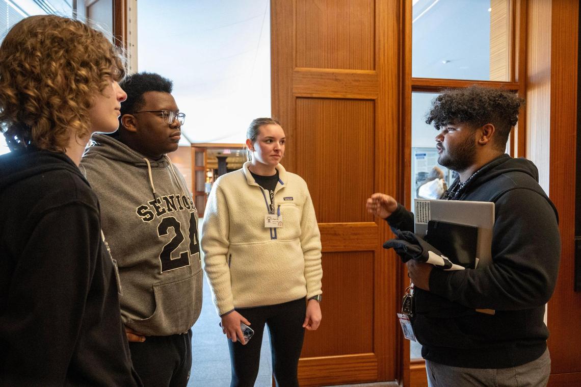DJ Yearwood, right, a youth advocate, talks to a group of high school seniors including Abi Storjohann, 17, from left, Reggie Locke,18, and Piper Keltner, 18, about the KC Youth and Young Adult Commissions for the City of Kansas City during a student event with American Public Square on Wednesday, Feb. 28, 2024, at the Central Library in Downtown Kansas City.Yearwood would like to get more young adults involved in civic engagement in Kansas City Storjohann and Keltner are students at Belton High School, and Locke is a student at University Academy.