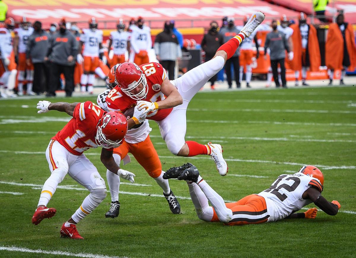 Kansas City Chiefs tight end Travis Kelce flies over Cleveland Browns strong safety Karl Joseph to score on a pass reception in the second quarter Sunday, January 17, 2021, at Arrowhead Stadium in Kansas City, Missouri.