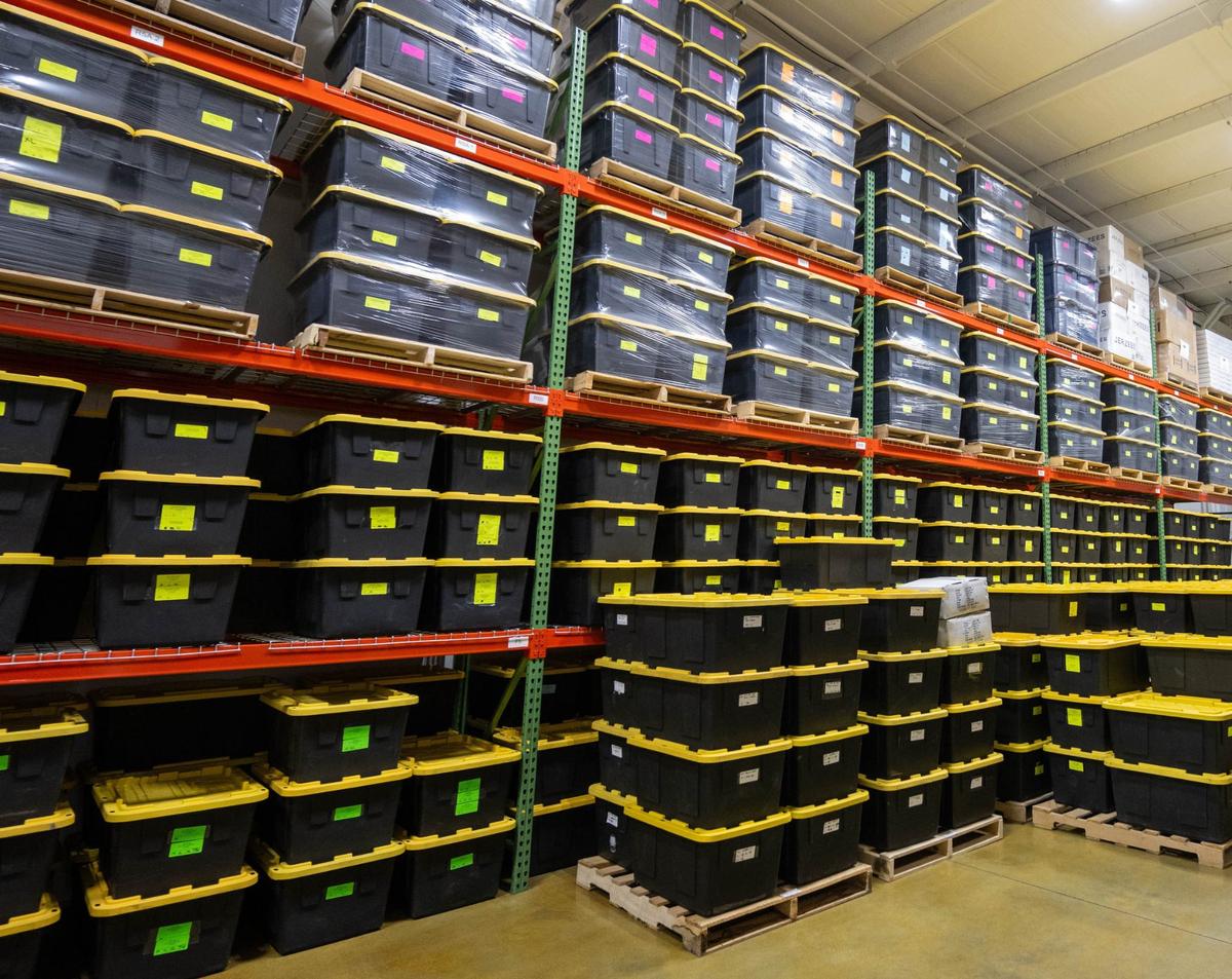 The warehouse section stores tour merchandise, everything wrapped, labeled, and sealed for easy access. The totes are then taken out on the road during tours and sold to the loyal fan base.