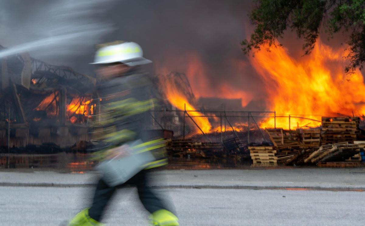 Flames engulf stacks of pallets at Pioneer Pallet in the 3500 block of Nicholson Ave. on Thursday, June 15, 2023, in Kansas City.