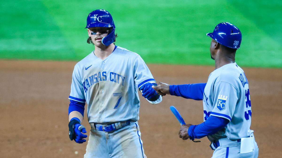 Kansas City Royals shortstop Bobby Witt Jr., left, celebrates with first base coach Damon Hollins after hitting a single during the seventh inning Wednesday at the Texas Rangers.