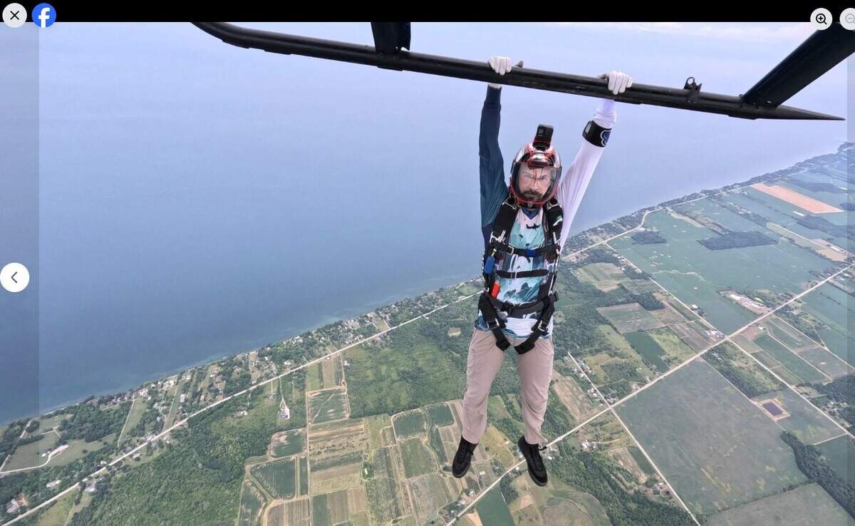 Marcus Miller, pictured dangling from a helicopter landing skid, is one of 11 skydivers and a pilot who died Sunday, June 14, 2026 when the skydiving plane crashed shortly after takeoff from an airfield in Butler, Missouri.
