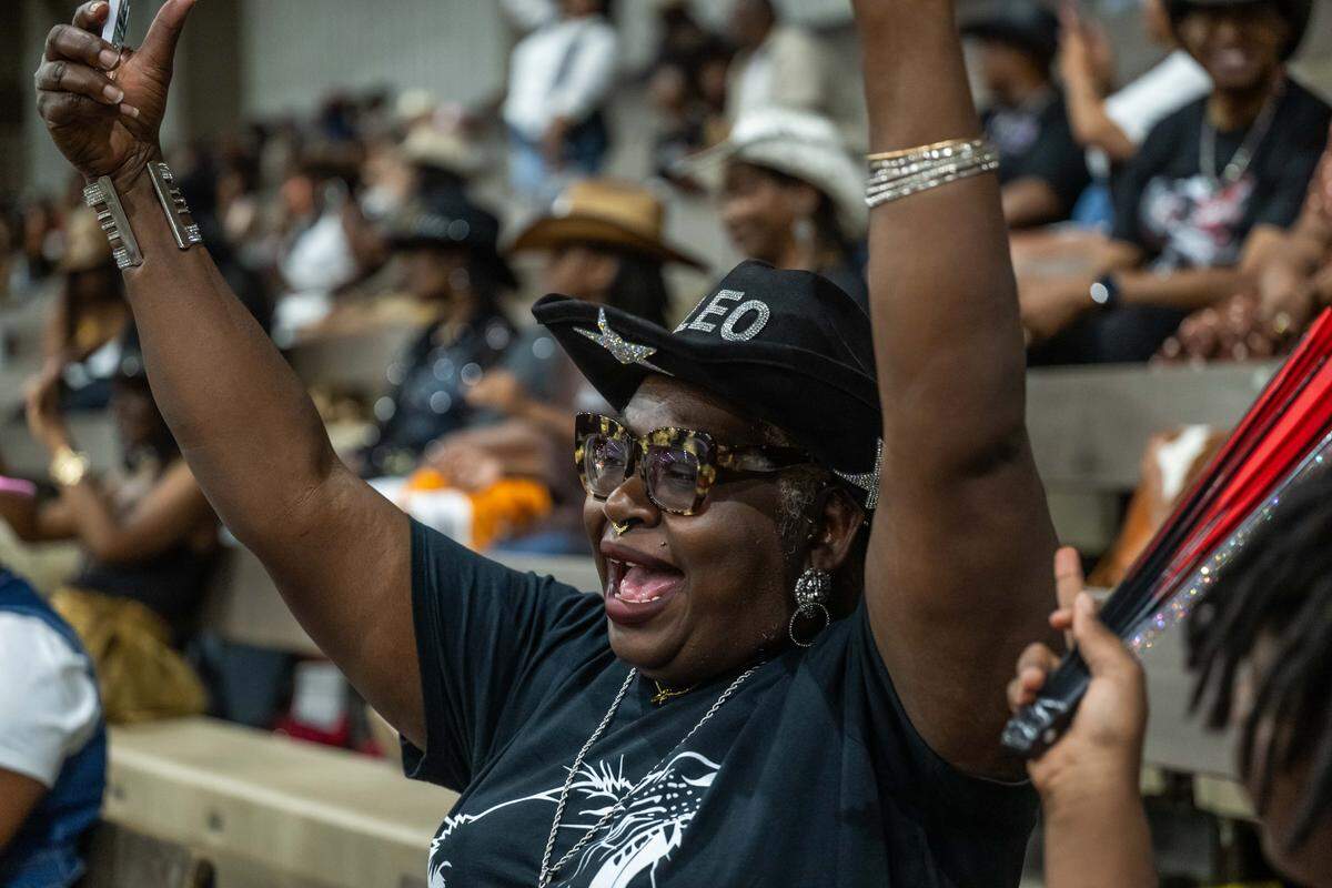 Tennille Hawkins shouts as the announcer singles out astrology signs during the Black Rodeo USA Saturday at Hale Arena.