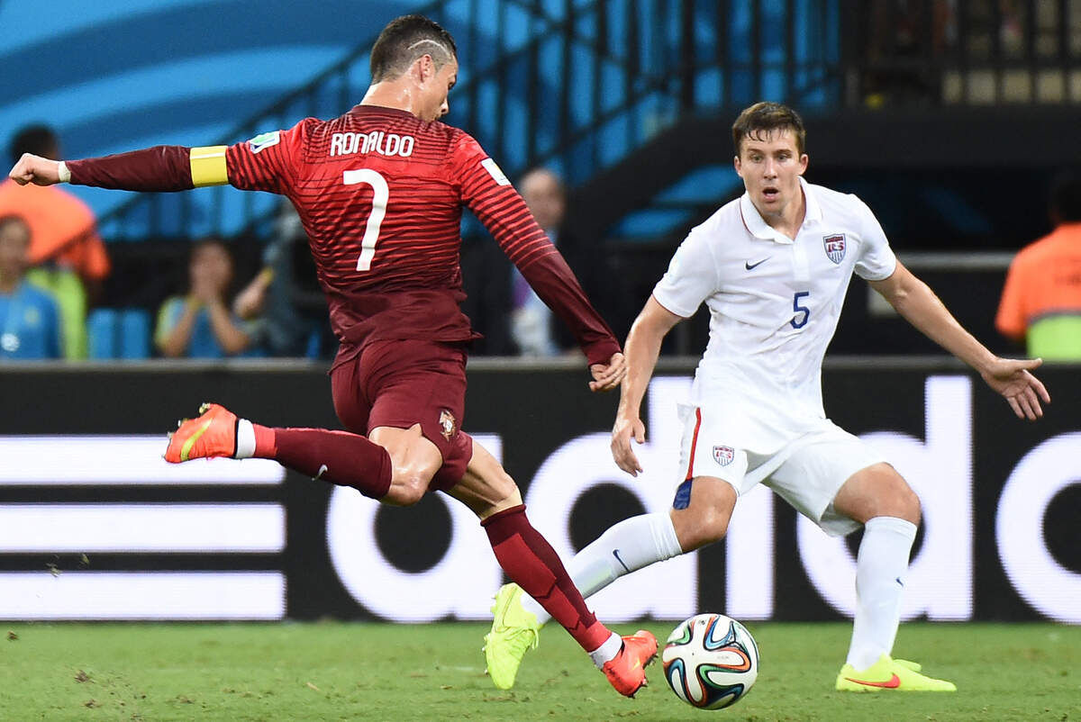 Portugal forward Cristiano Ronaldo (L) in action against U.S. defender Matt Besler during a Group G match between USA and Portugal at the Amazonia Arena in Manaus during the 2014 FIFA World Cup on June 22, 2014.