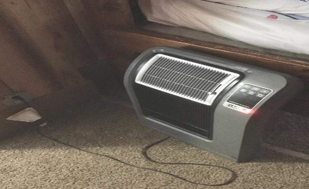 An electric heater is shown next to a child’s bed.