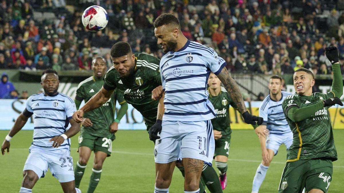 Sporting Kansas City forward Khiry Shelton (No. 11) heads the ball off a corner kick during Monday night’s MLS season opener against the Portland Timbers Providence Park.