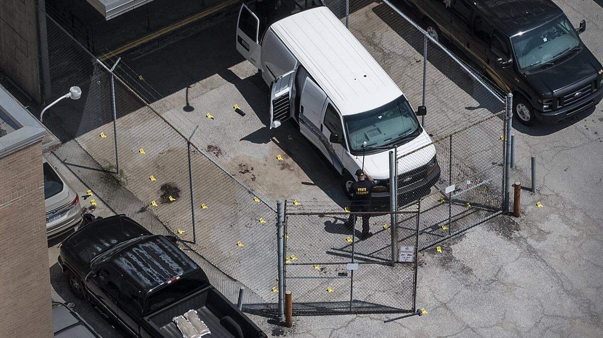 Markers dot the pavement where shell casings and evidence was marked just outside the Wyandotte County courthouse where two deputies were shot by an inmate they were transferring.