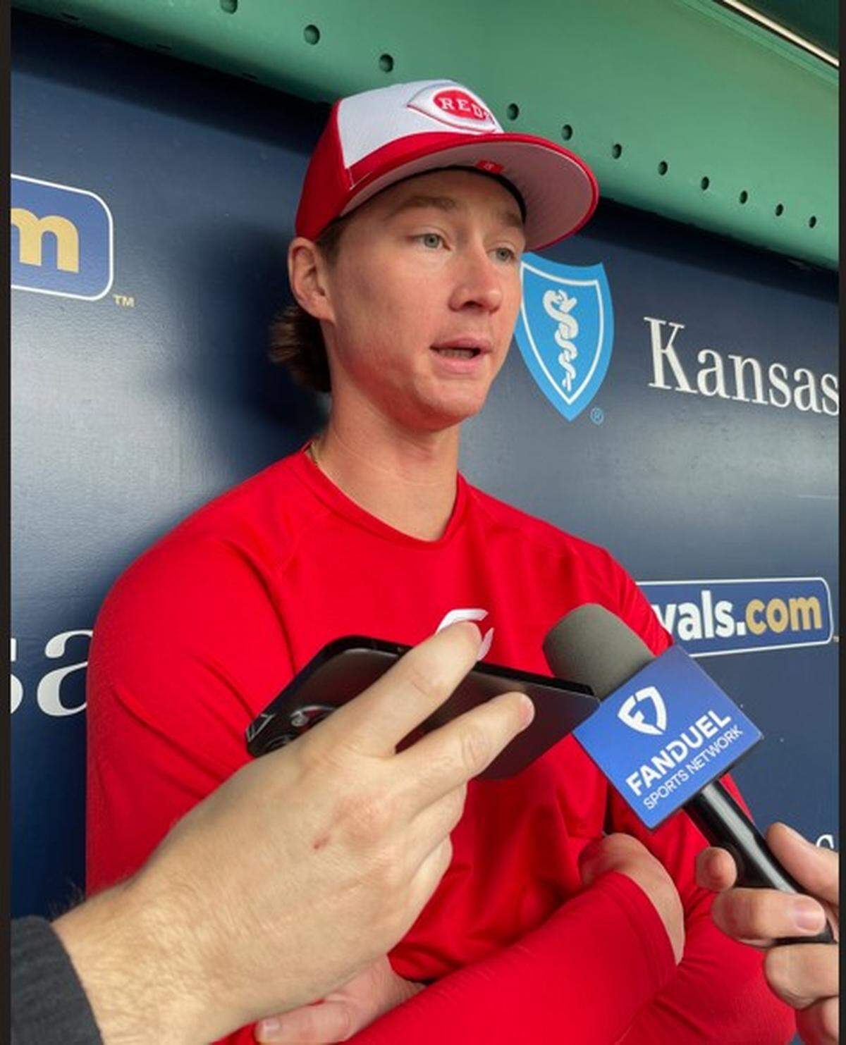 Brady Singer in the visiting dugout at Kauffman Stadium ahead on Monday.