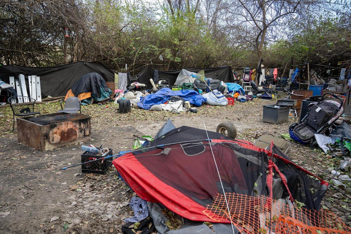 Piles of debris surround tents and tarps at a homeless camp north of the Columbus Park neighborhood.