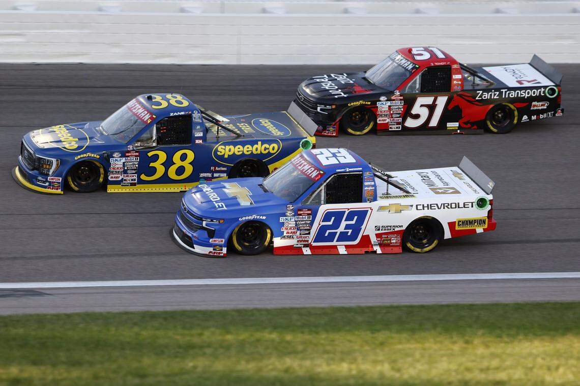 NASCAR Truck Series driver Zane Smith (38), driver Grant Enfinger (23) and driver Kyle Busch (51) race during the Heart of America 200 at Kansas Speedway on May 6, 2023.