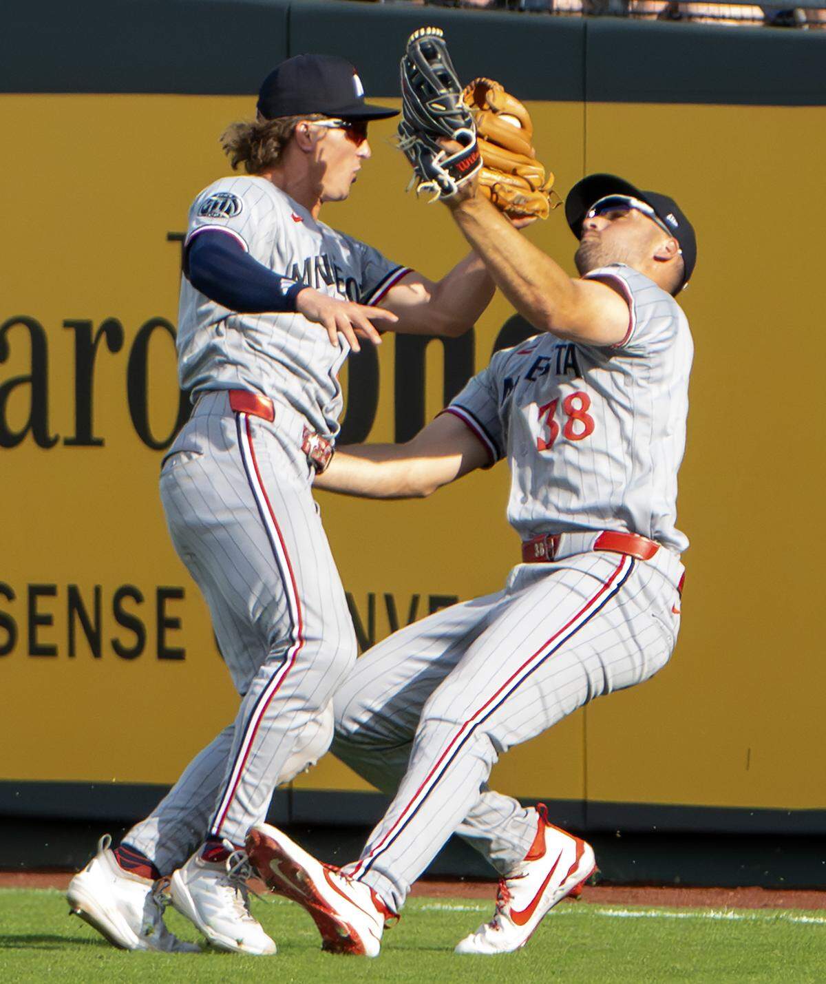 Minnesota Twins second baseman Luke Keaschall (15) and right fielder Matt Wallner (38) collide after catching a fly ball in the eighth inning during a game against the Kansas City Royals at Kauffman Stadium on Monday, March 30, 2026, in Kansas City.