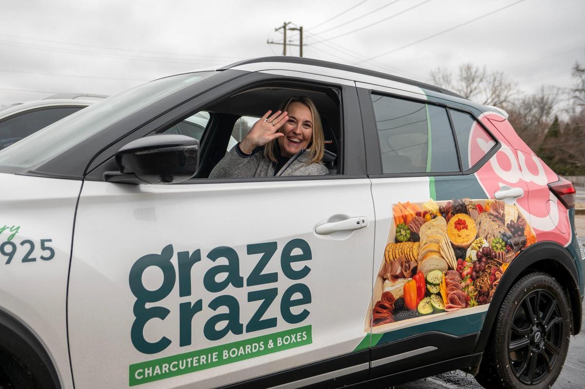 Susan Paulakovich, owner of Graze Craze, waves from her delivery car.