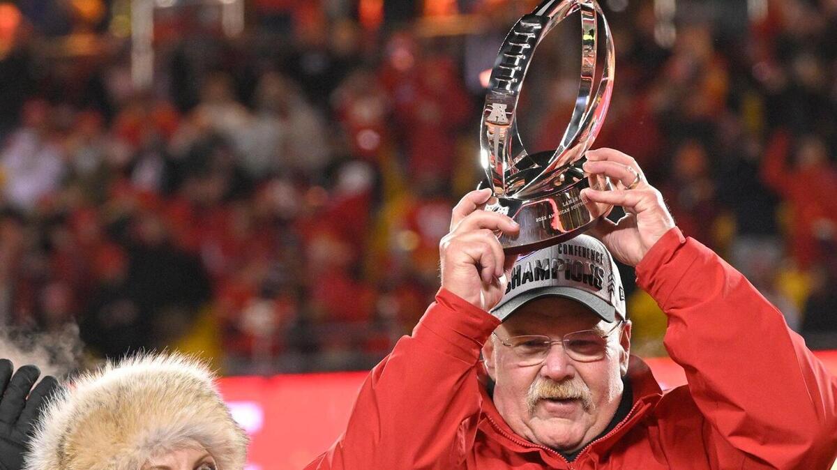 Tammy Reid looked on as Kansas City Chiefs head coach Andy Reid hoisted the Lamar Hunt Trophy as the team celebrated after defeating the Cincinnati Bengals, 23-20, in the AFC Championship Game on Sunday.