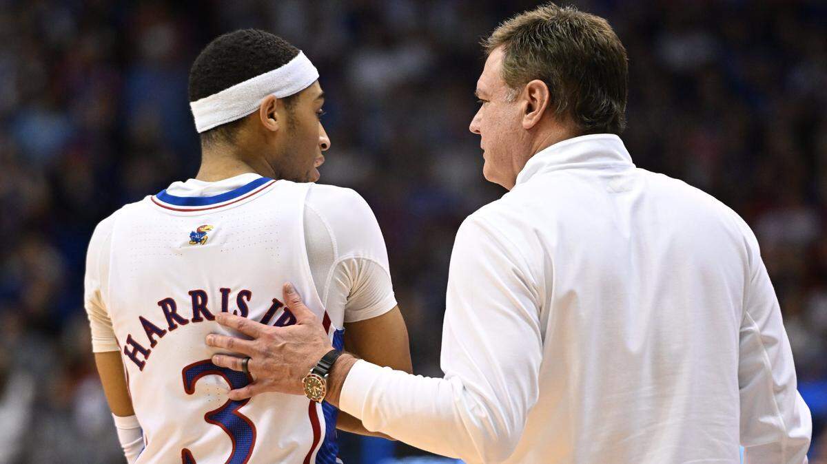 KU’s Dajuan Harris visits with coach Bill Self during the second half of a 2022-23 Big 12 Conference game vs. K-State at Allen Fieldhouse.