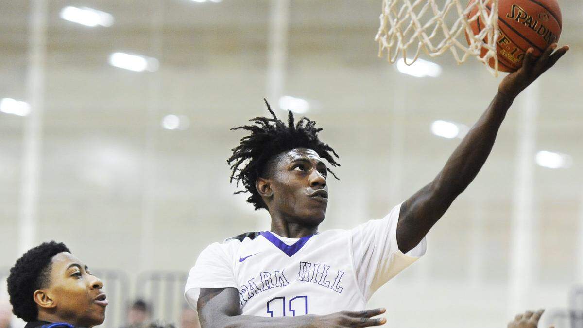 Park Hill South guard Lamel Robinson (11) moves in for a layup ahead of Raytown guard Karl Jackson during Friday afternoon’s game, Dec. 28, 2018, at William Jewell College in Liberty. Park Hill South won 69-53 in the Patterson Division semi-final game of the 39th Annual William Jewell High School Holiday Classic, which concludes Saturday, Dec. 29.