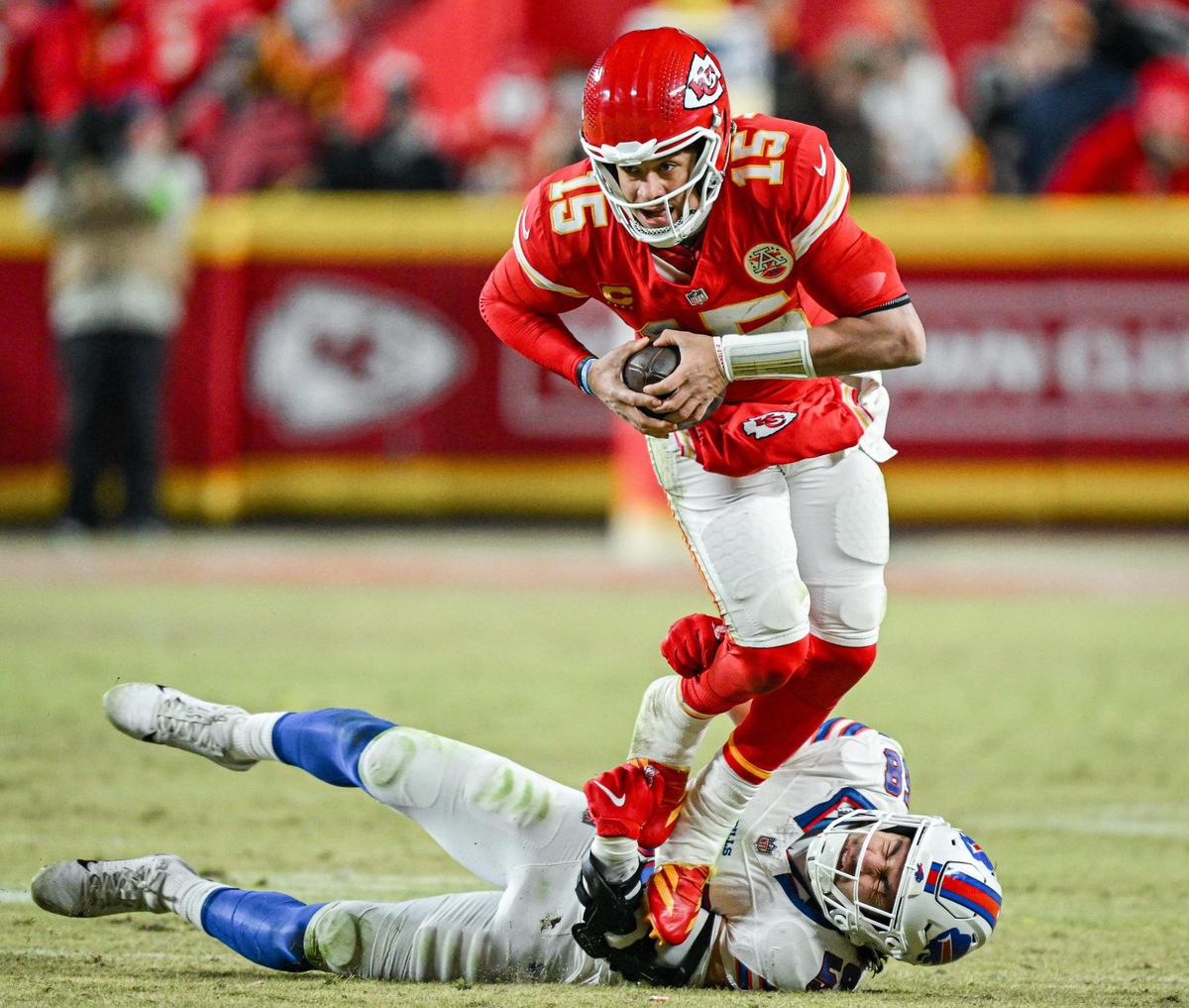 Kansas City Chiefs quarterback Patrick Mahomes (15) tries to scramble in the third quarter but is grabbed by Buffalo Bills linebacker Matt Milano (58) during the AFC Championship Game on Sunday, Jan. 26, 2025, at GEHA Field at Arrowhead Stadium.