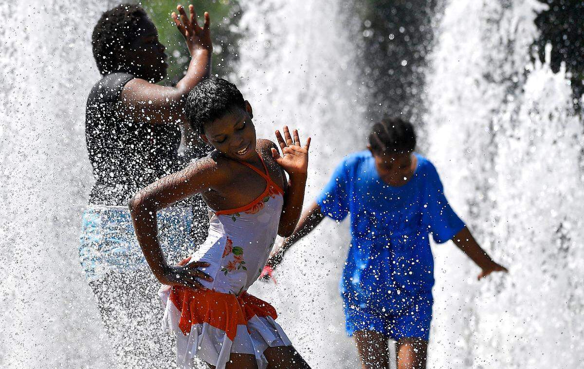 On one July afternoon, oppressive heat and humidity made life outdoors in Kansas City a miserable affair, but for nine-year-old Anna Claire, middle, it was all about fun in the sun with her her fellow campmates from Grace United Church in Northeast K.C. As the mercury pushed into the upper 90’s and the heat index climbed to 110 degrees, the group cooled off at Concourse fountain in George Kessler Park.
