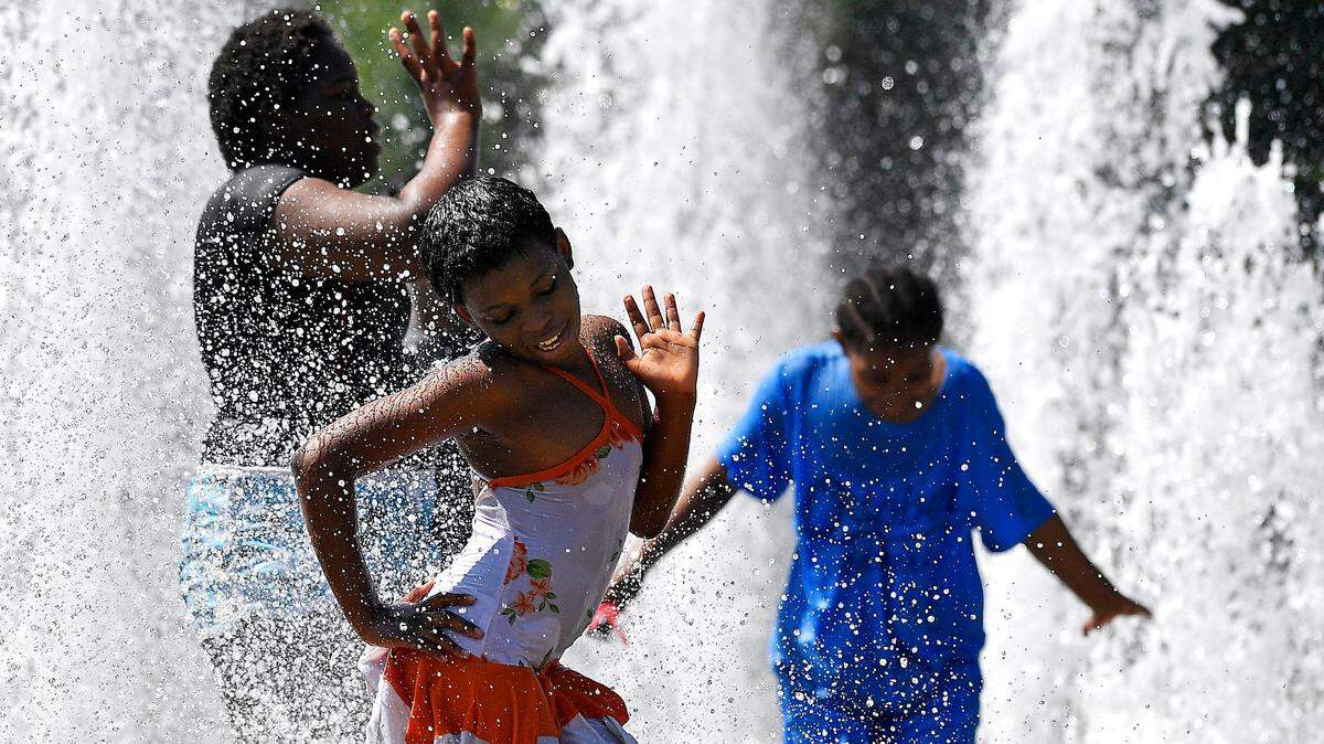 On one July afternoon, oppressive heat and humidity made life outdoors in Kansas City a miserable affair, but for nine-year-old Anna Claire, middle, it was all about fun in the sun with her her fellow campmates from Grace United Church in Northeast K.C. As the mercury pushed into the upper 90’s and the heat index climbed to 110 degrees, the group cooled off at Concourse fountain in George Kessler Park.